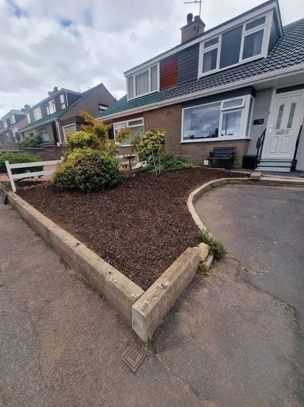 The same front bed cleared to soil inside the sleeper edges
