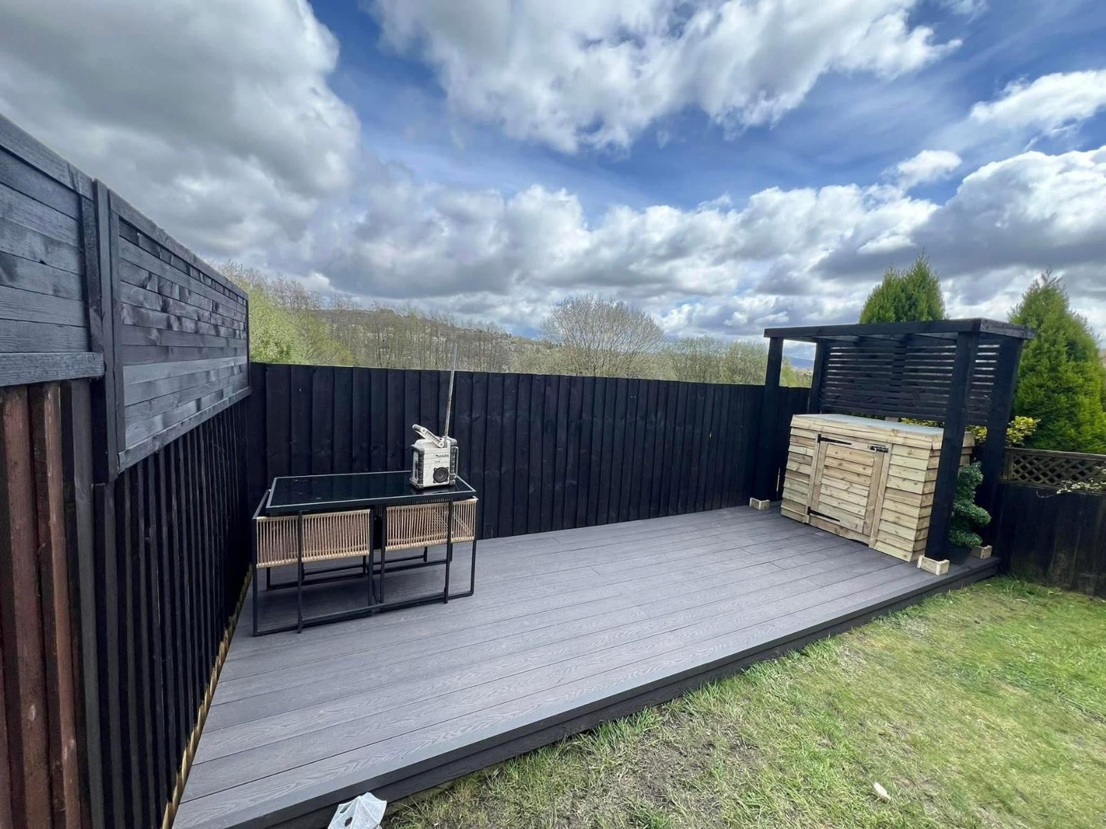 Grey composite deck with a black screen and pergola