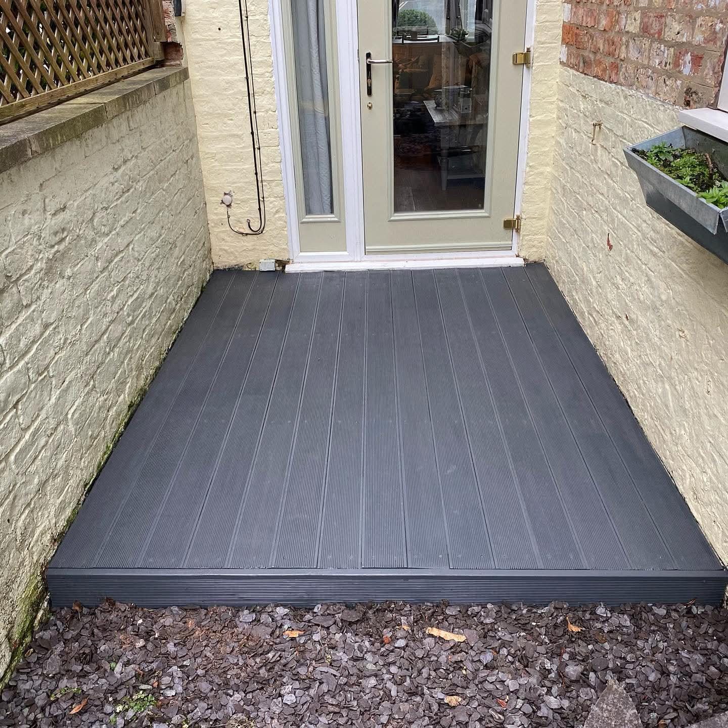 New grey composite deck outside the same back door