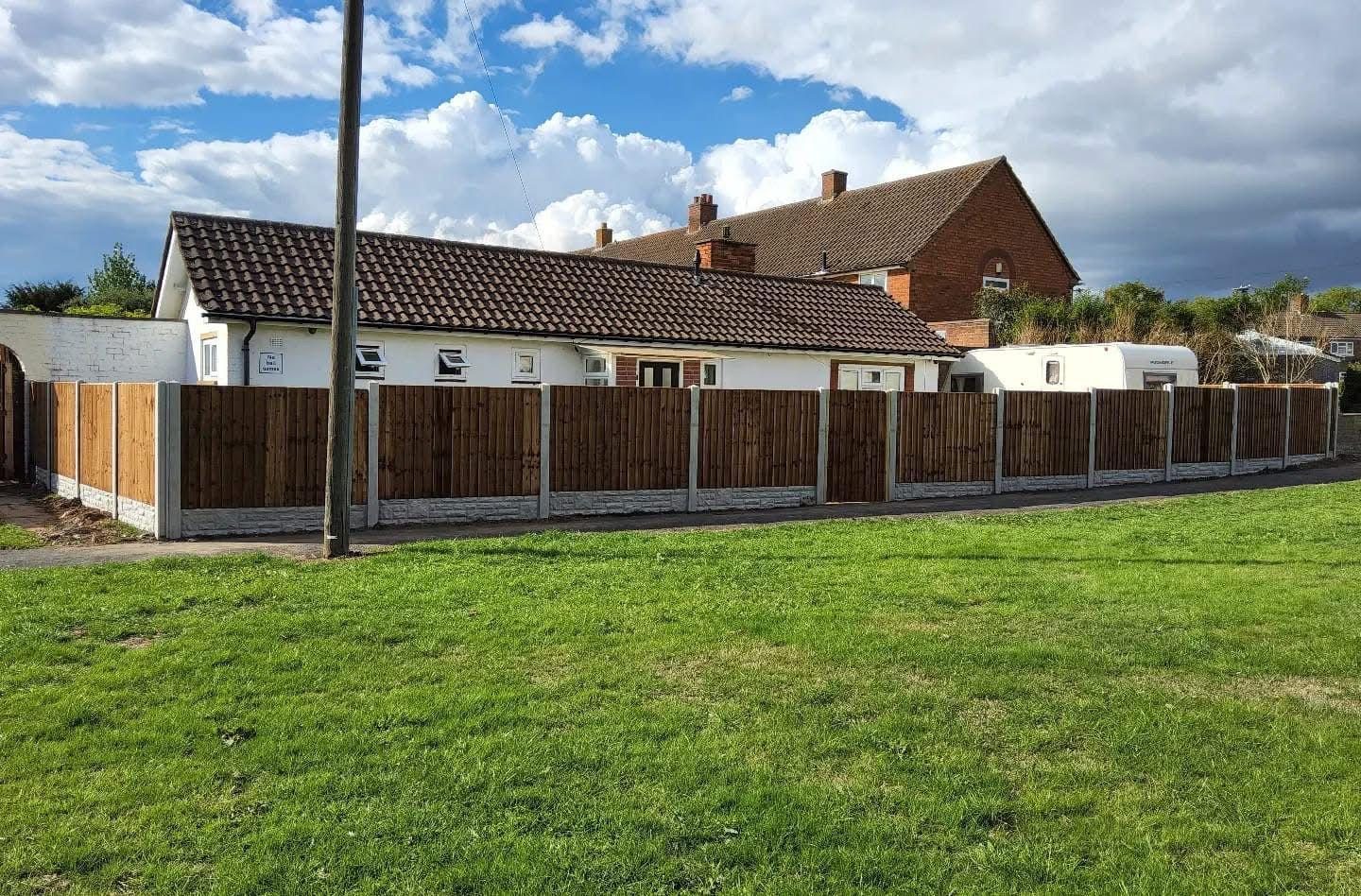 New featheredge fence in front of the same bungalow