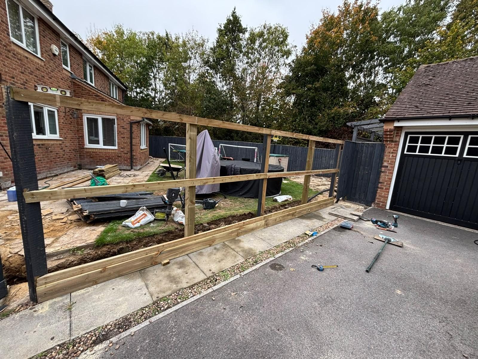 Timber fence frame going in beside a driveway