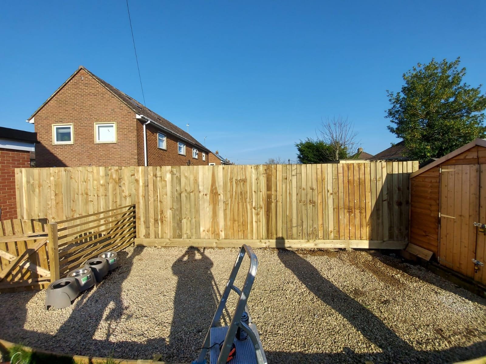 New closeboard fence at the back of a gravel yard