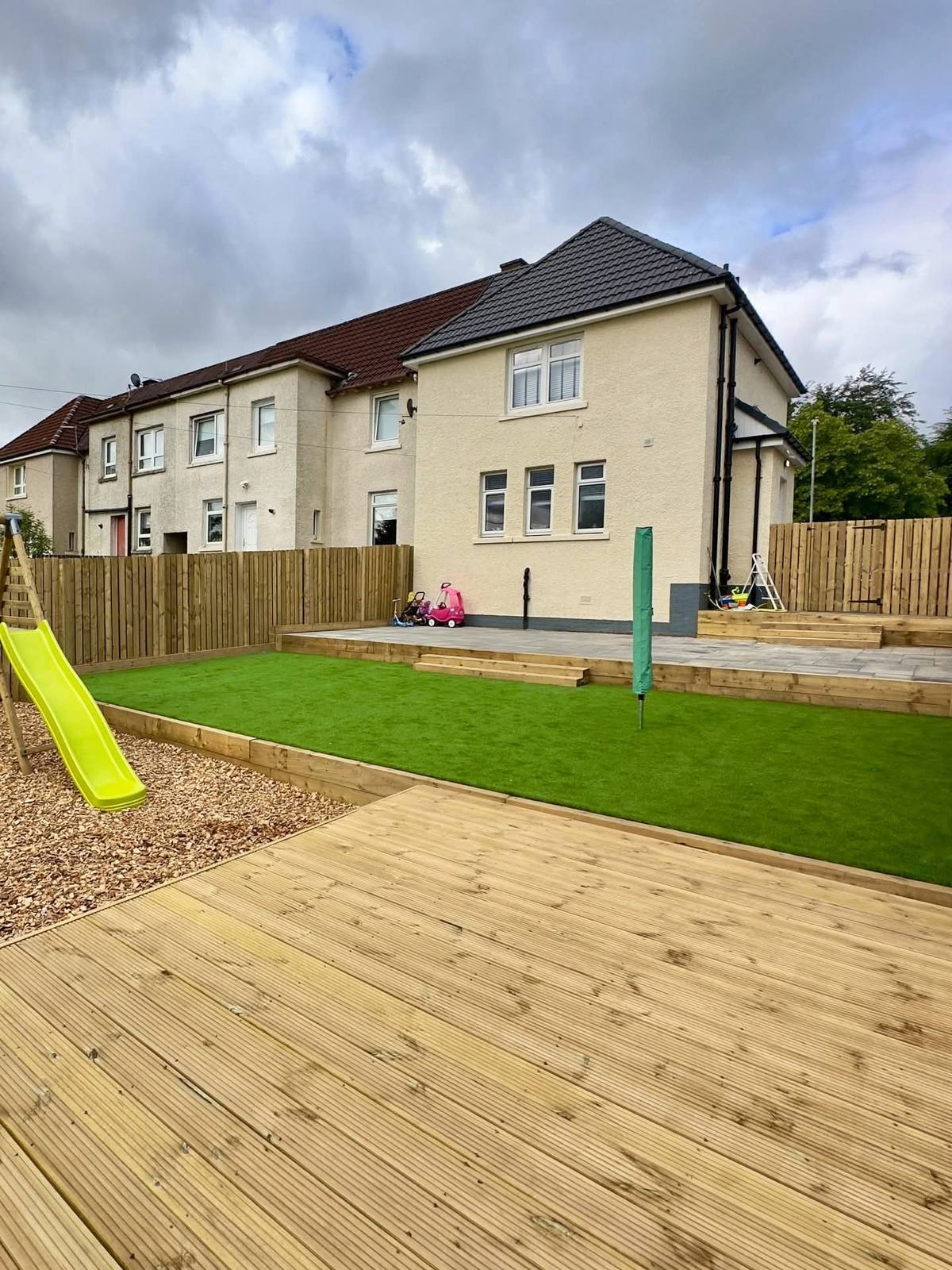 New deck, artificial lawn and fenced play area at the same house