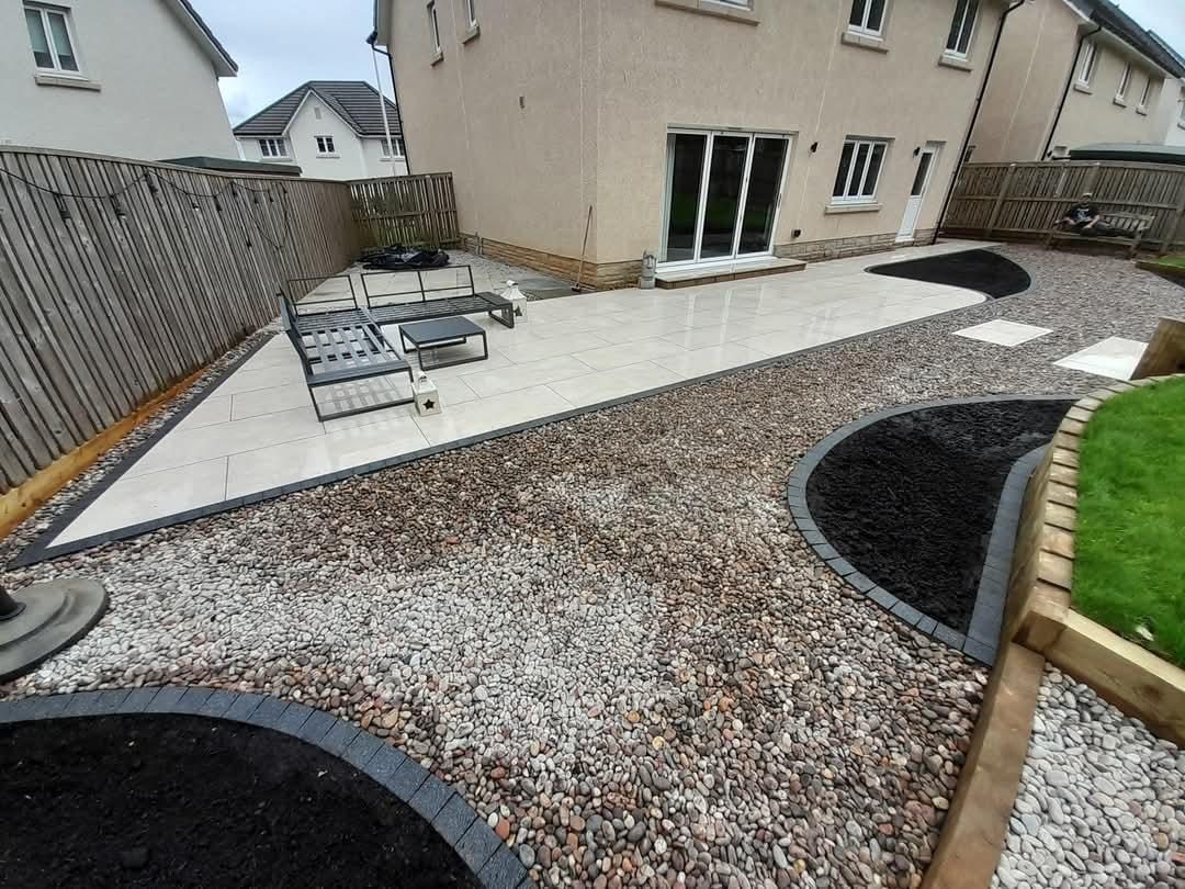 Cream porcelain patio with gravel and curved planting beds