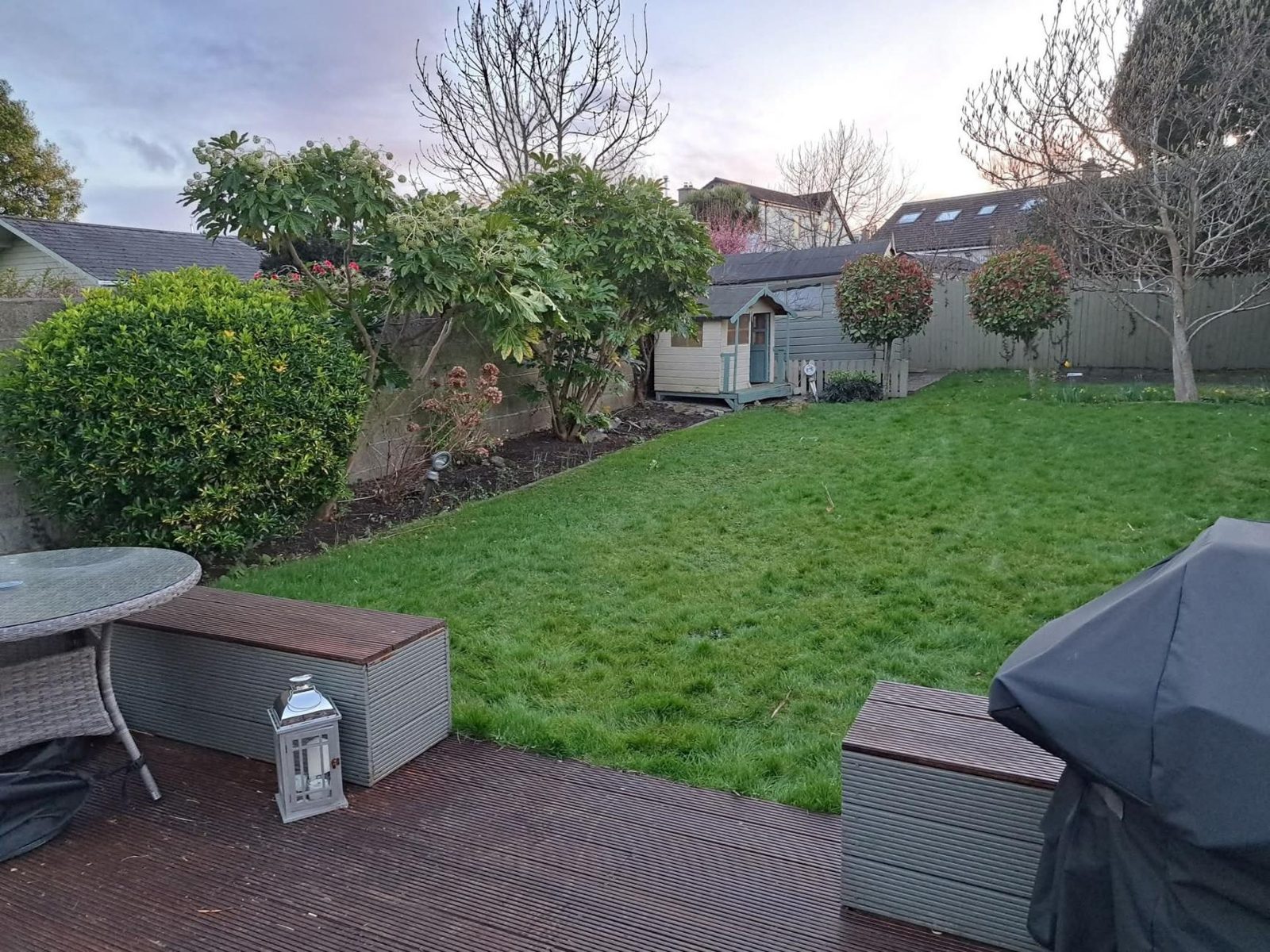 Composite deck and lawn with a playhouse
