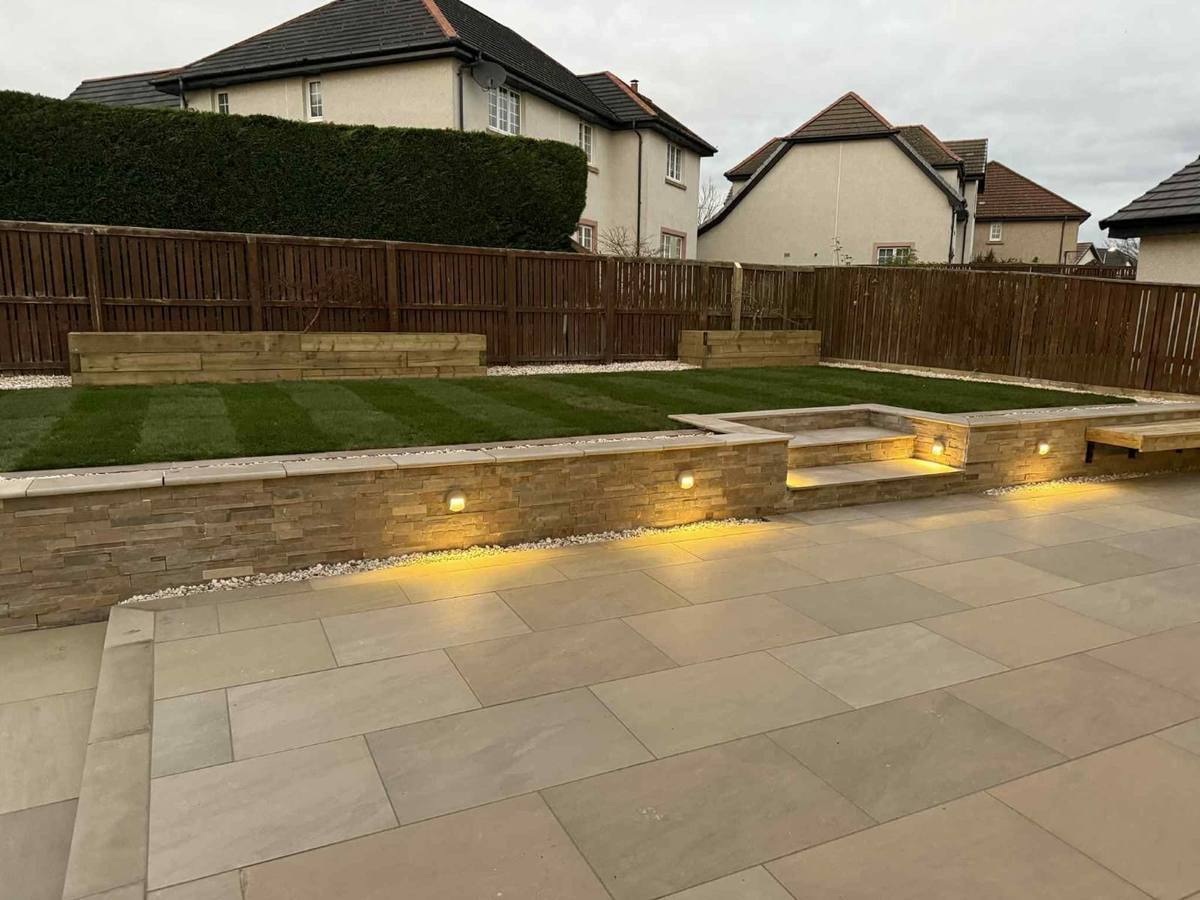 Finished stone wall with lights, steps and a porcelain patio