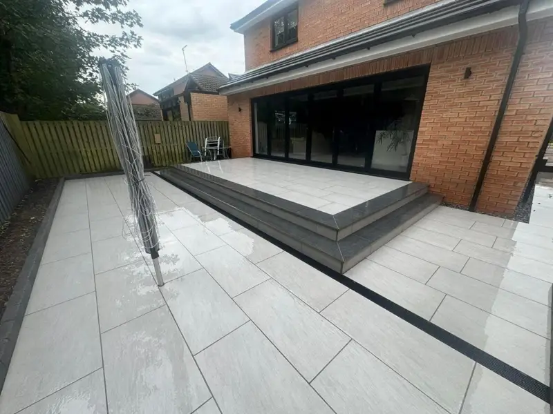 Light porcelain patio with steps outside the same bifold doors