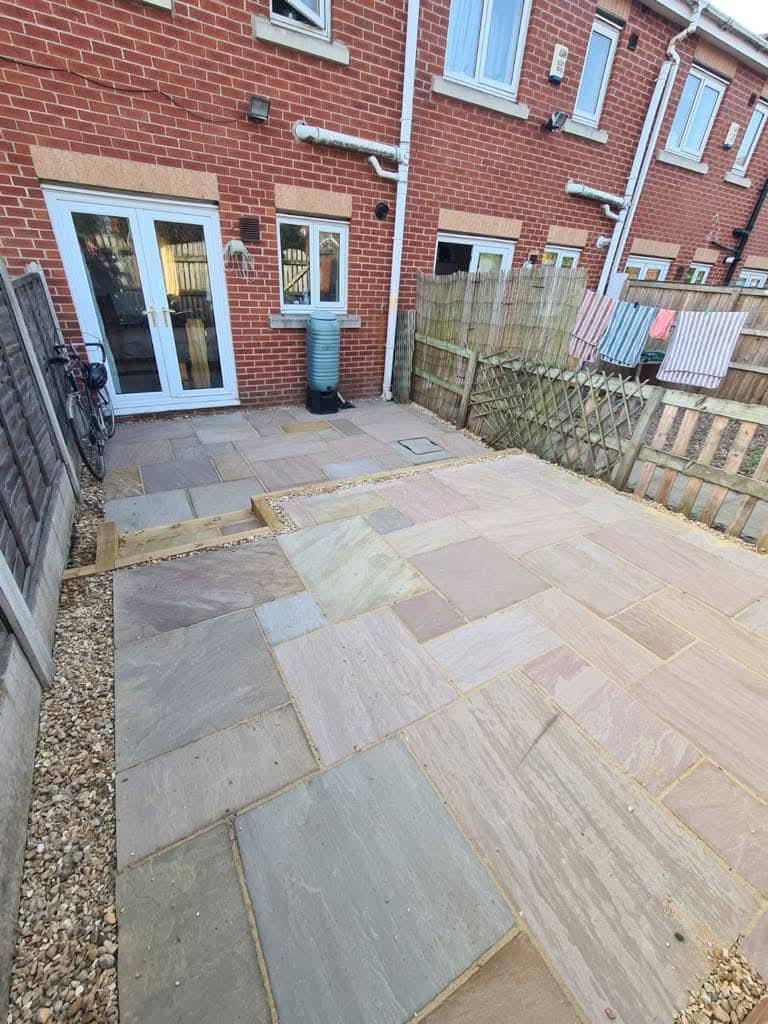 New sandstone patio outside the same doors