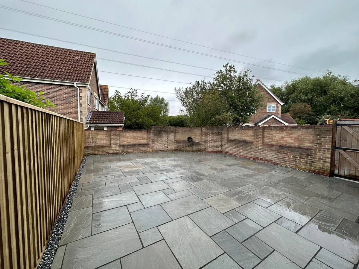 The same garden paved with large grey slabs