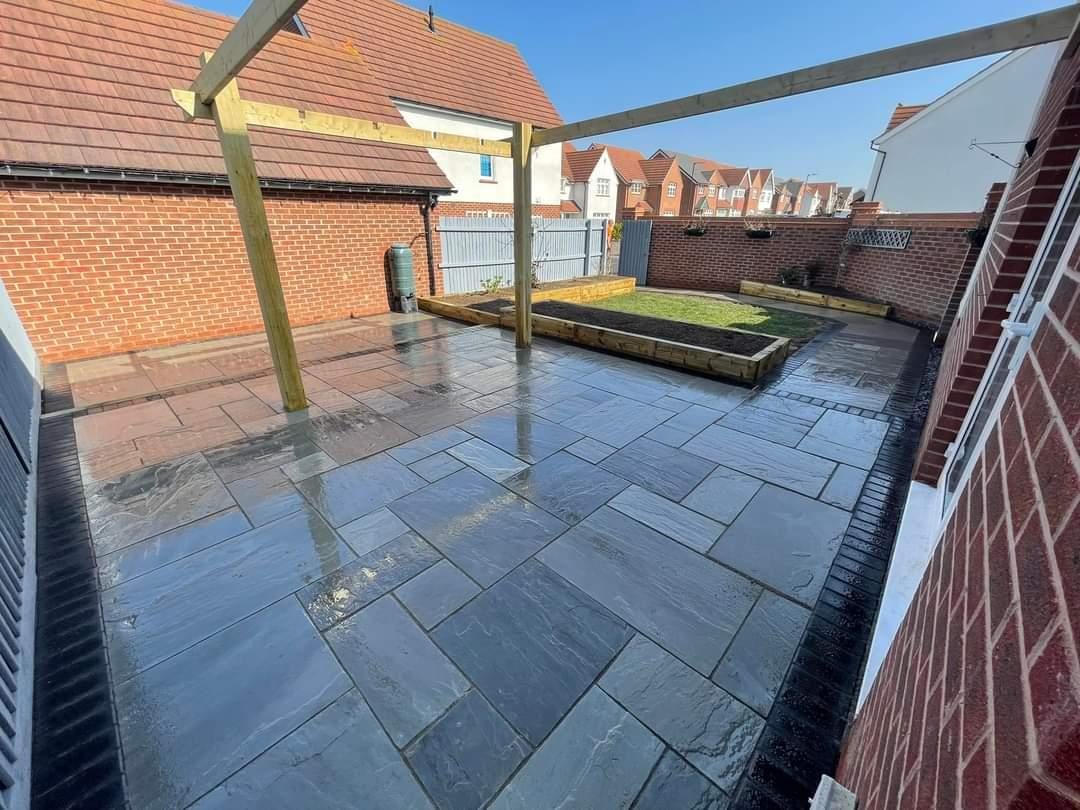 Dark porcelain patio under the same pergola