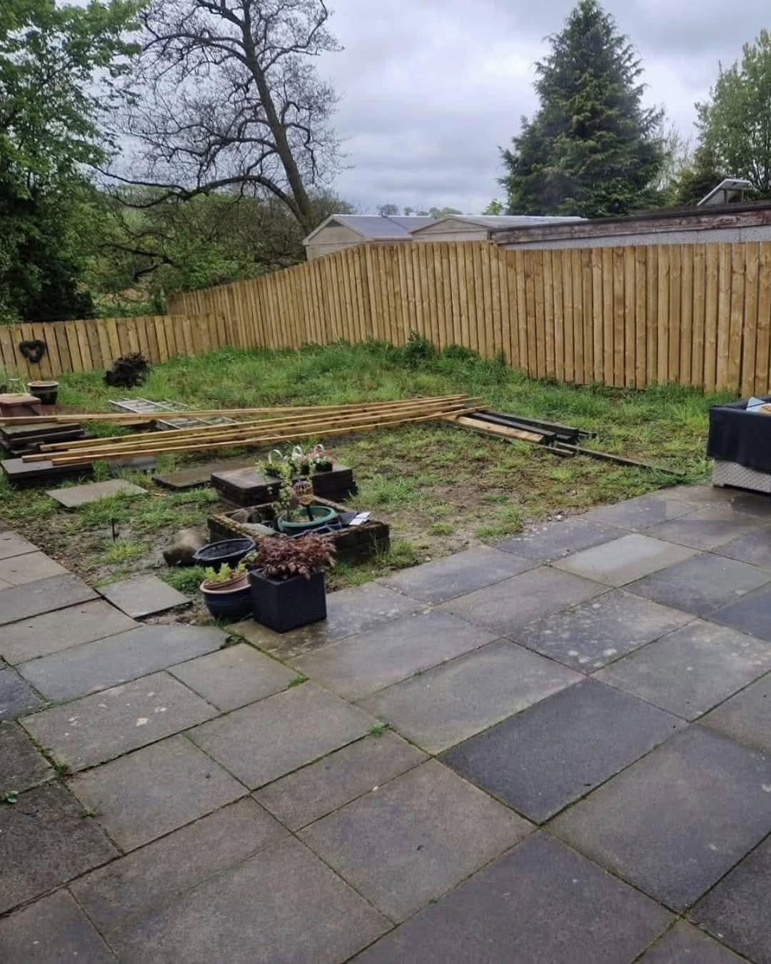 Old concrete slabs and stacked timber before a patio