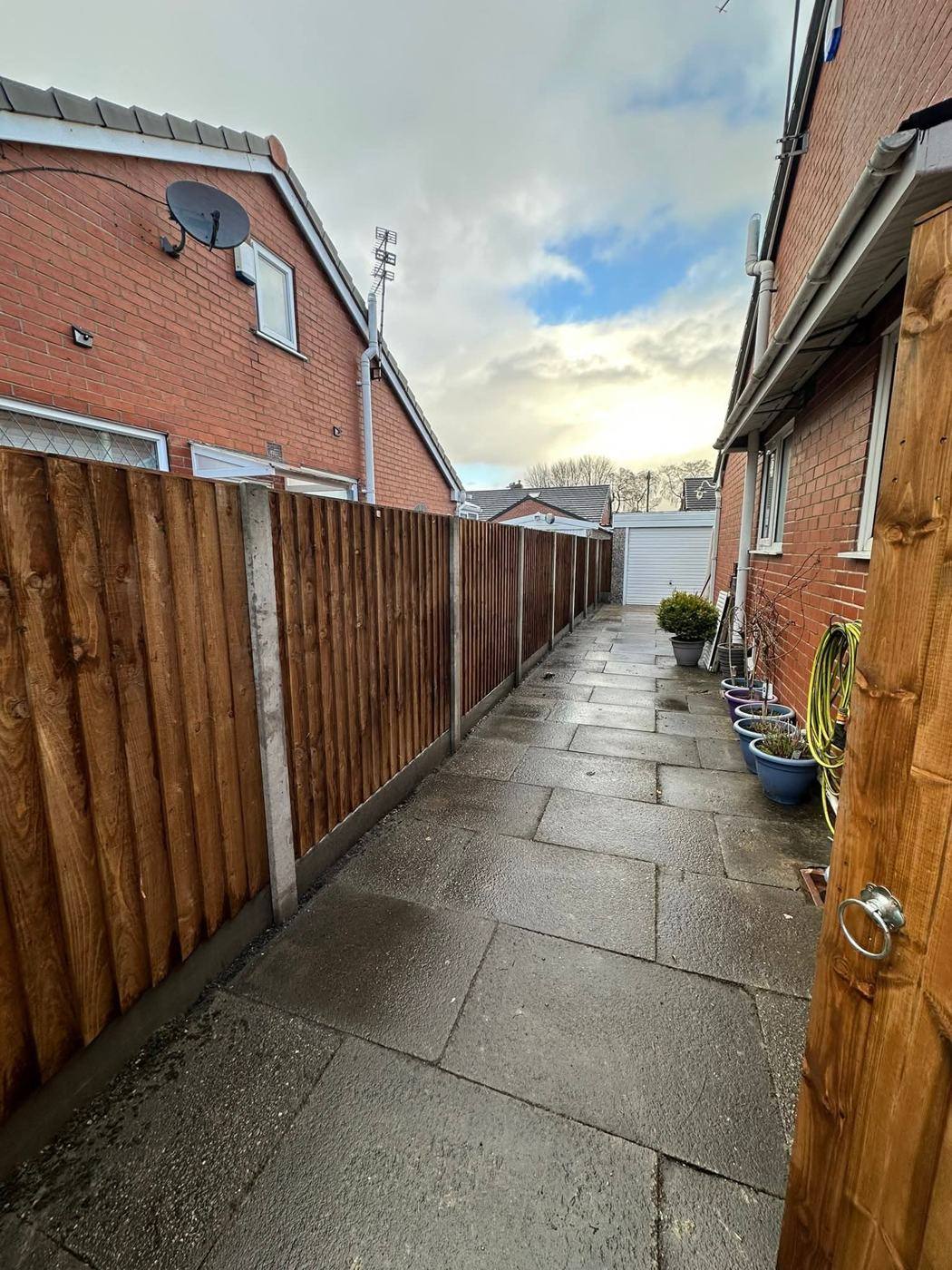 The same alley closed in with new feather-edge fence panels