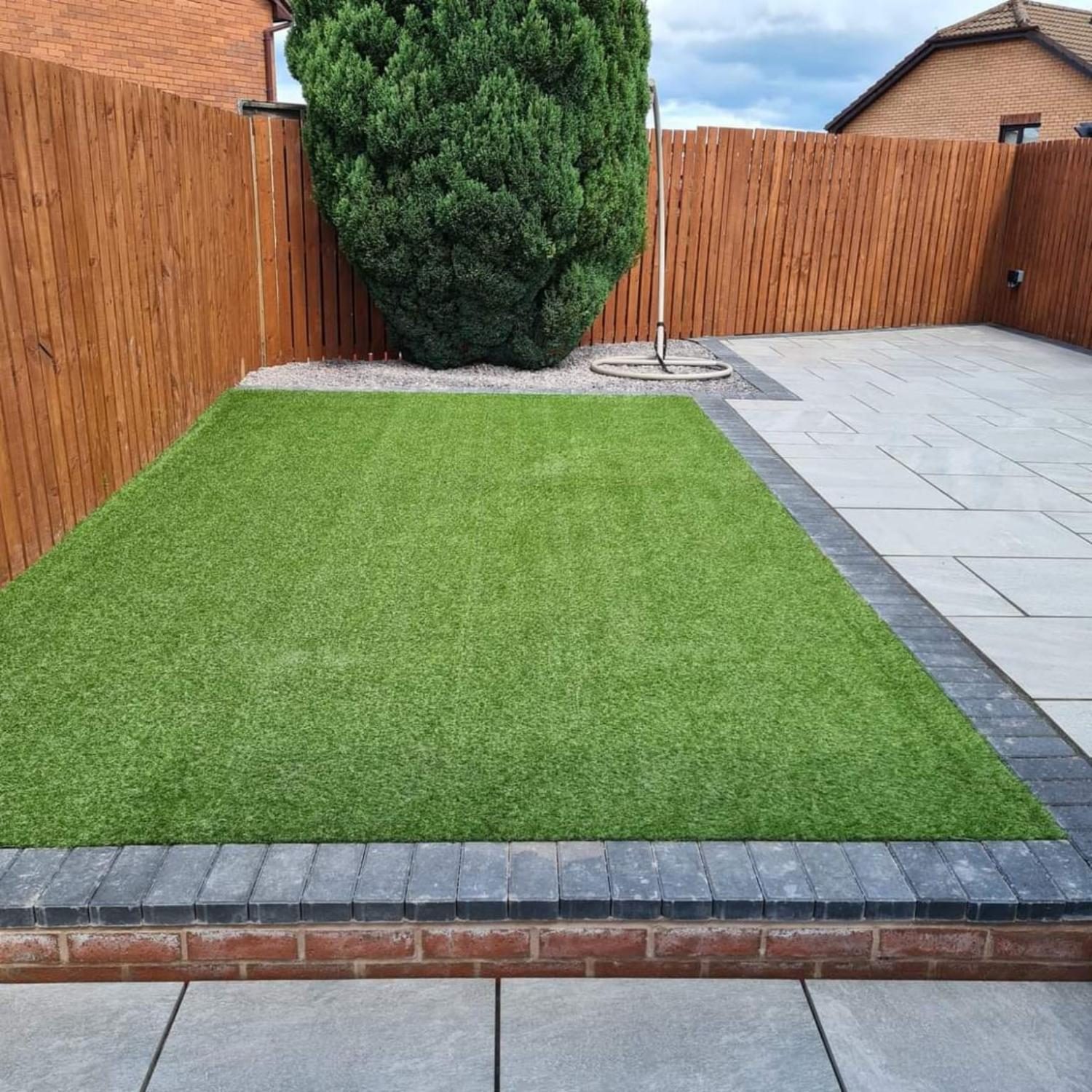 Artificial grass and grey paving in the same garden