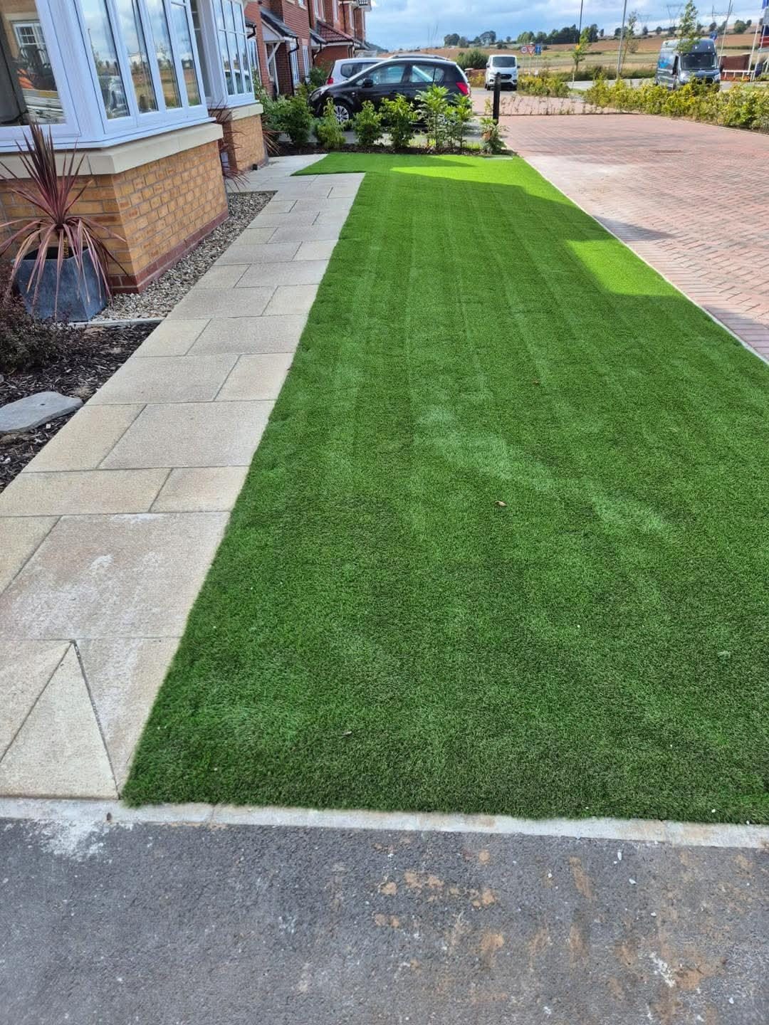 Artificial grass in the same strip beside the drive